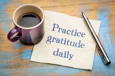 Napkin with “practice gratitude daily” written on it in pen